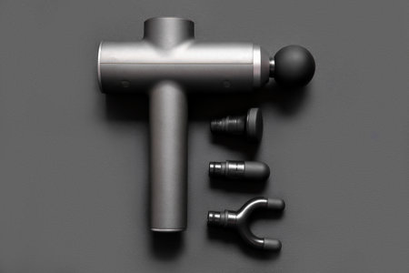 Percussive massager and different nozzles on dark backgroundの写真素材