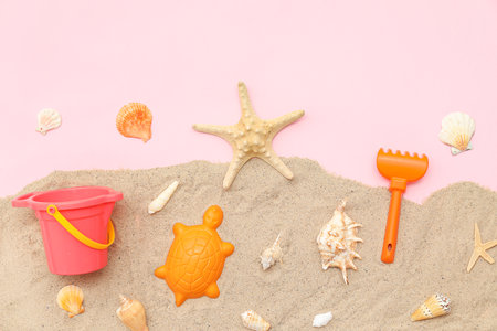 Beach accessories for children and shells on pink background. Top viewの写真素材