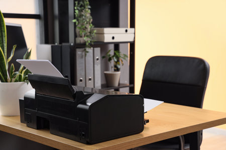 Modern printer on desk in office, closeup