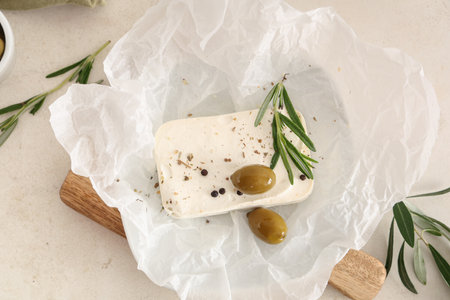 Paper with tasty feta cheese, olives, rosemary and peppercorn on white backgroundの写真素材