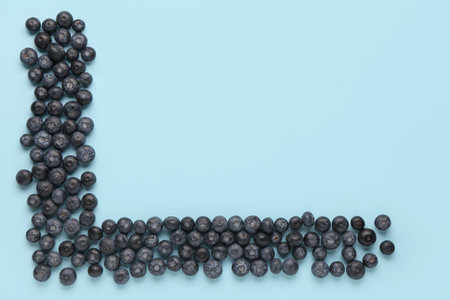 Sweet fresh blueberries on blue background