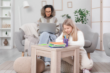 Little girl with tutor studying at homeの写真素材