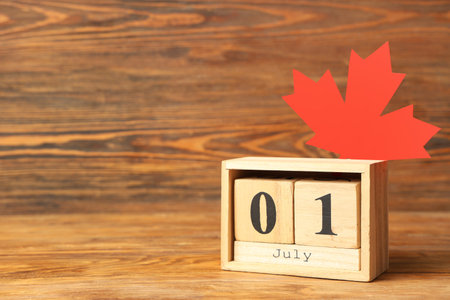 Calendar and Maple leaf on wooden background. Canada Day conceptの写真素材