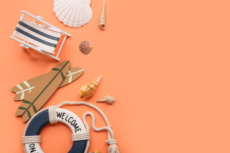 Deckchair, surf boards, lifebuoy ring and seashells on orange background. Summer conceptの写真素材