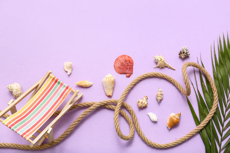 Palm leaves, deckchair and seashells on lilac background. Summer conceptの写真素材