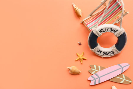 Beautiful seashells, surf boards, deckchair and lifebuoy ring on orange background. Summer conceptの写真素材