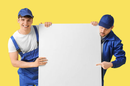 Loaders with blank poster on yellow backgroundの写真素材