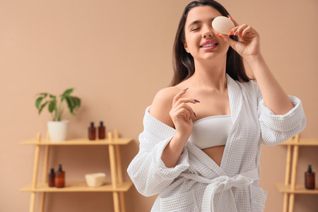 Smiling young woman with soap in bathroomの写真素材