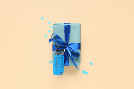 Gift box with car key on beige background. Father's day celebration. Top viewの写真素材