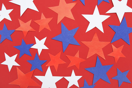 Stars in colors of USA flag on red background. American Independence Day celebrationの写真素材