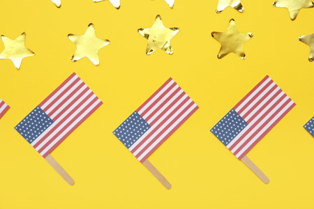 USA flags and stars on yellow background. American Independence Day celebration