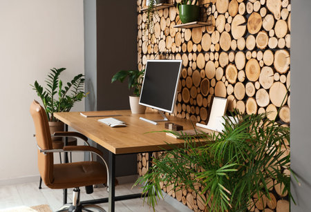 Workplace with computer and plants in officeの写真素材