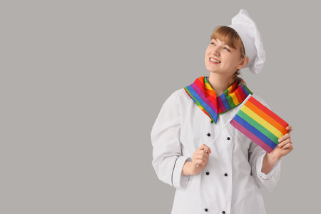 Female chef with LGBT flag on light backgroundの写真素材