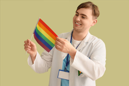 Male dentist with LGBT flag on green backgroundの写真素材