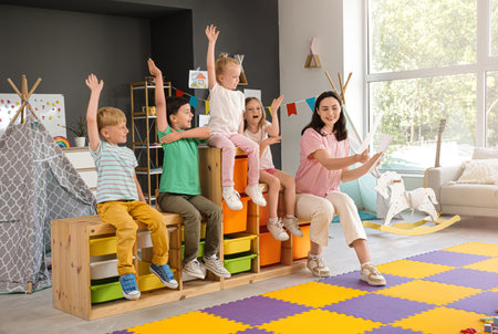 Little children with nursery teacher learning letters in kindergartenの写真素材