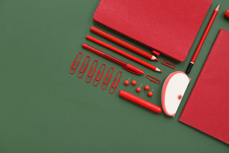 Composition with different stationery on green background