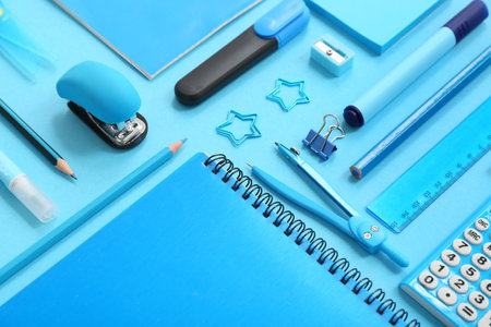 Composition with notebooks and different stationery on blue background, closeupの写真素材