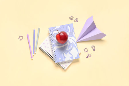 Tasty apple, paper airplane and different school stationery on beige background