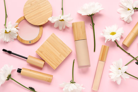 Beautiful composition with flowers and decorative cosmetics on pink background, closeupの写真素材