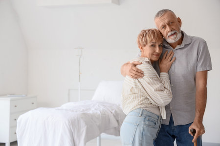 Mature couple hugging in clinicの写真素材