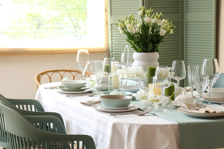 Beautiful table setting with white flowers for wedding celebration in room
