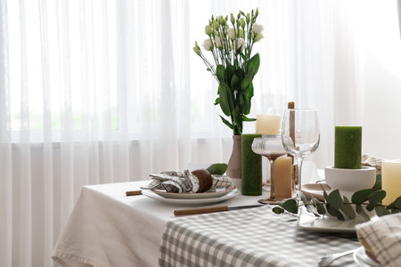Beautiful table setting with eustoma flowers and eucalyptus for wedding celebration in roomの写真素材