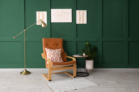 Cozy armchair, coffee table and pictures on wall in living room
