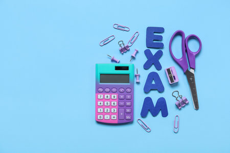 Composition with word EXAM and different stationery on color background