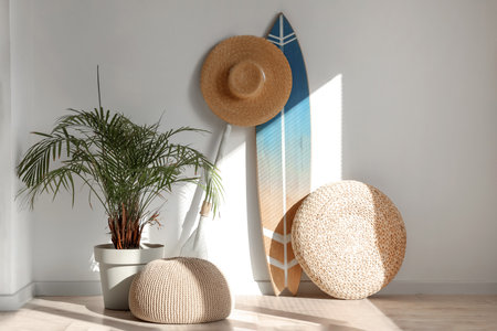 Surfboard with hat and poufs in light roomの写真素材
