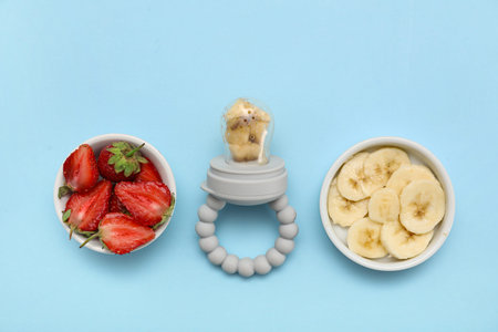 Baby nibbler and ripe fruits on color background