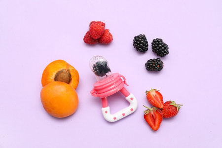 Composition with baby nibbler and fruits on lilac background