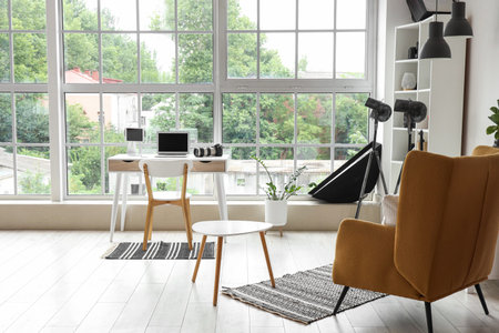 Interior of photographer's office with workplace, armchair and equipmentの写真素材