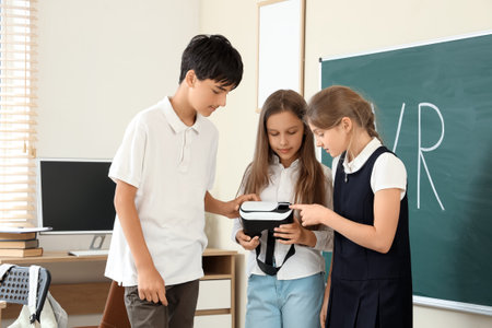 Pupils with VR glasses in classroomの写真素材