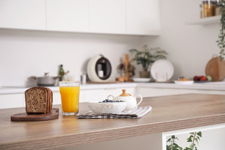 Blueberries with juice and bread on table in kitchen, closeupの写真素材