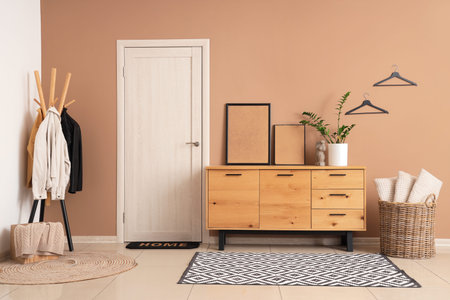Stylish interior of modern hall with sideboard and coat rackの写真素材