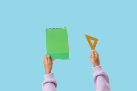Child with notebook and ruler on blue background