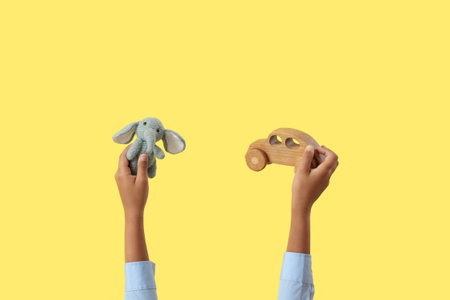 Child with toys on yellow backgroundの写真素材