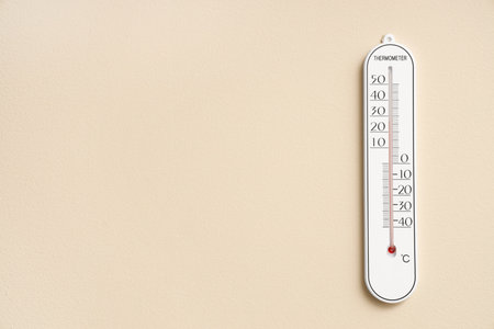 Home thermometer on light wallの写真素材