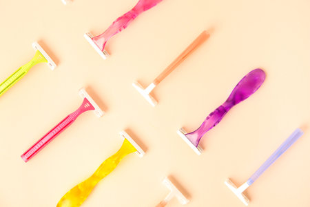 Different razors on beige background, closeup