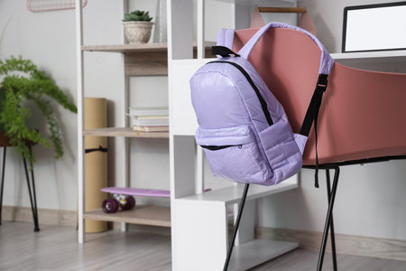 Lilac backpack on chair in children's roomの写真素材