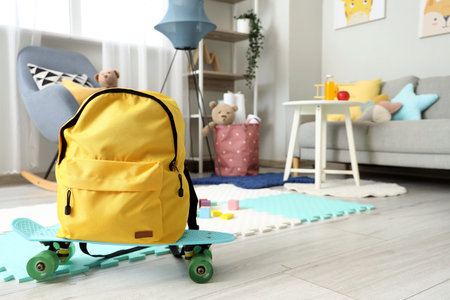 Yellow backpack on skateboard in children's room