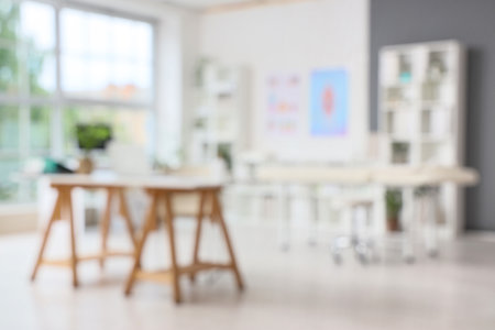Blurred view of medical office with workplaces, massage couch and shelf unitsの写真素材