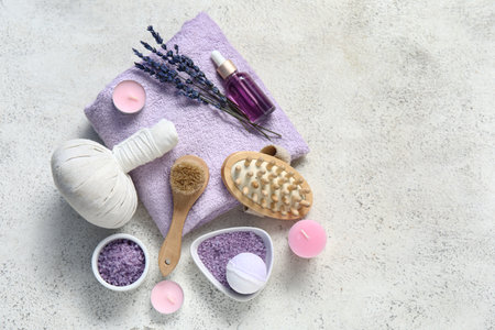 Beautiful composition with bath supplies, sea salt and bottle of lavender oil on grunge backgroundの写真素材