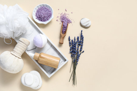 Beautiful composition with herbal bag, spa stones, lavender and bath bomb on beige backgroundの写真素材