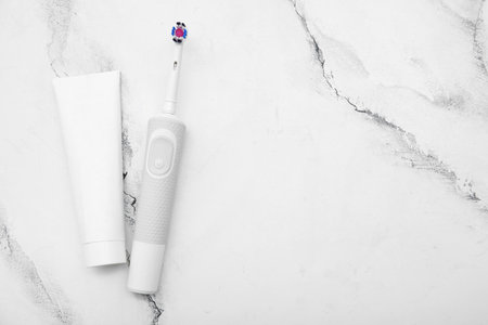 Electric toothbrush and paste on marble backgroundの写真素材