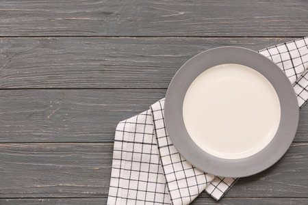 Table setting with plate and napkin on gray wooden backgroundの写真素材