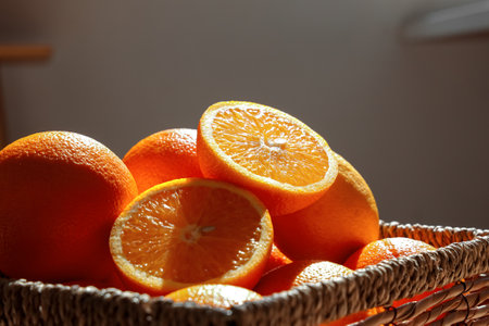 Wicker basket with citruses on coffee table in beautiful room, closeupの写真素材