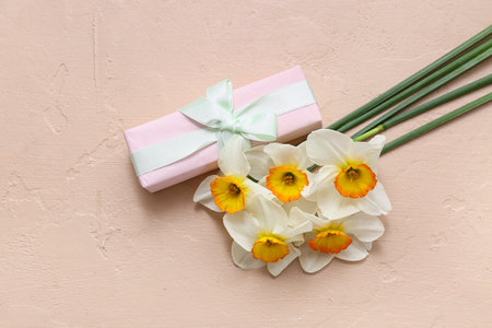 Daffodil flowers with gift on beige background. Top viewの写真素材