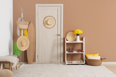 Stylish interior of modern hall with hanger, shelving unit and doorの写真素材