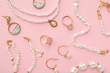Beautiful pearl jewelry on pink background. Top viewの写真素材